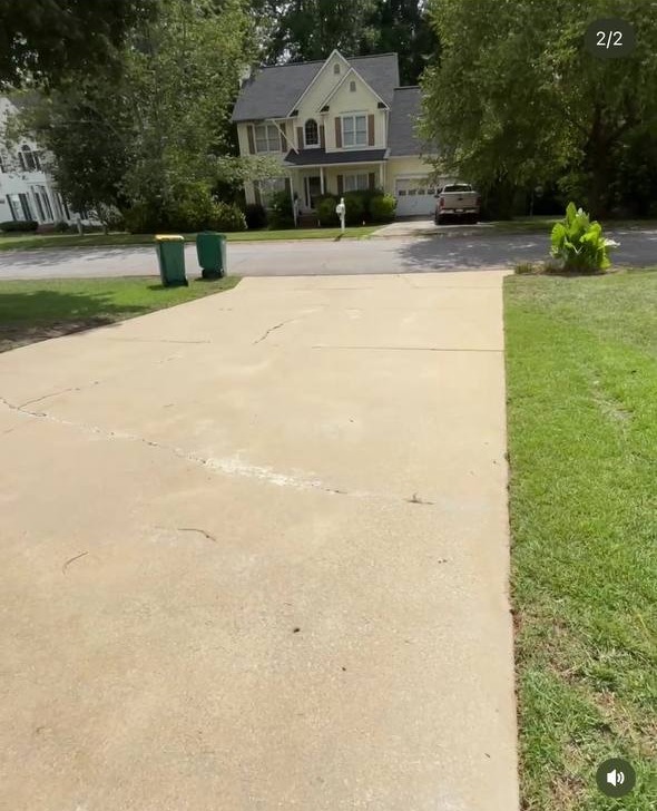 Freshly cleaned driveway after Top Tier Exteriors